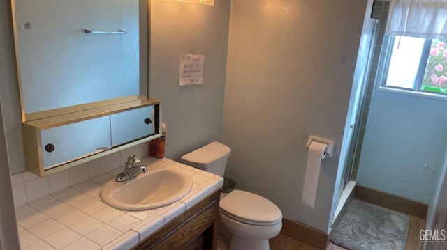 bathroom with walk in shower, vanity, and toilet