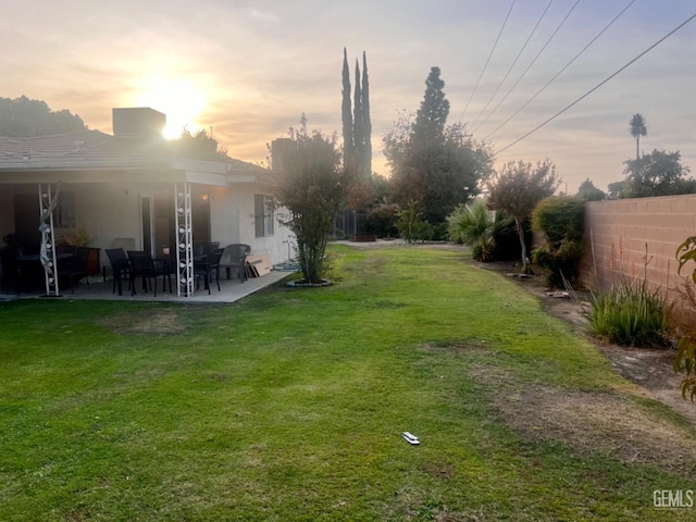 yard at dusk with a patio