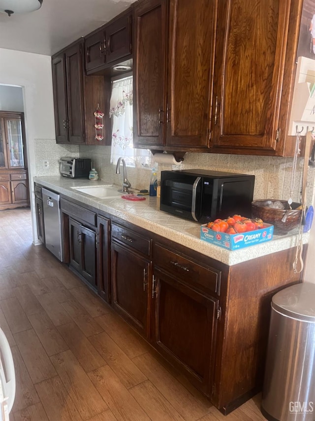 kitchen featuring a healthy amount of sunlight, dishwasher, light hardwood / wood-style floors, and sink