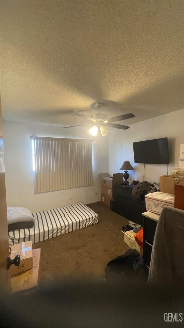 bedroom with carpet flooring, a textured ceiling, and ceiling fan