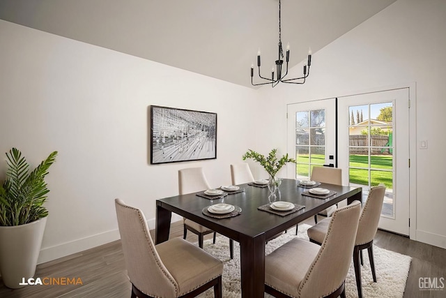 dining room featuring a chandelier, vaulted ceiling, and dark wood-type flooring