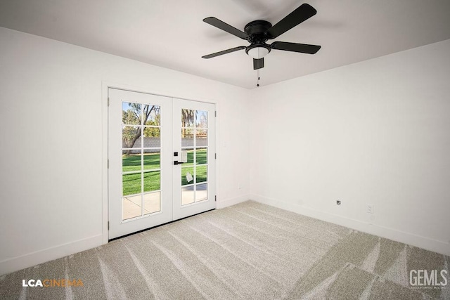 carpeted empty room featuring ceiling fan and french doors