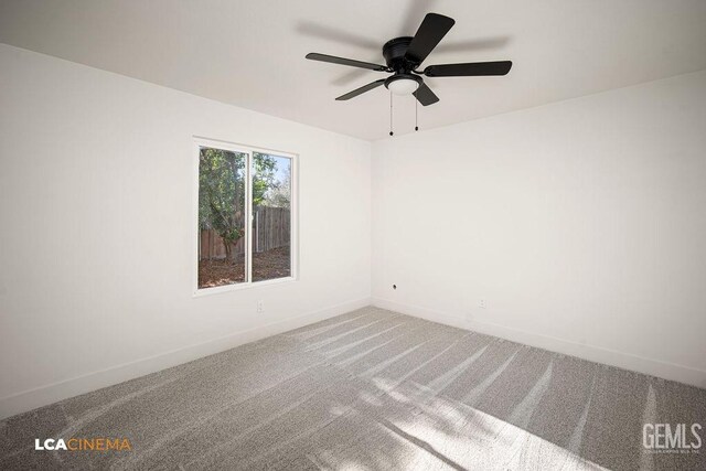 spare room featuring carpet and ceiling fan