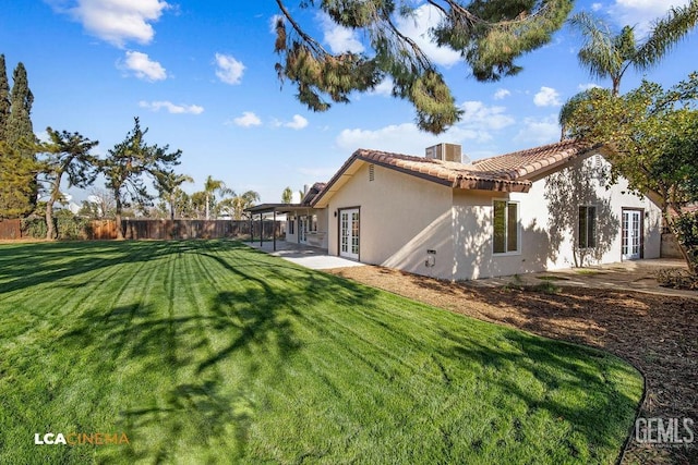 exterior space featuring a yard, french doors, and a patio