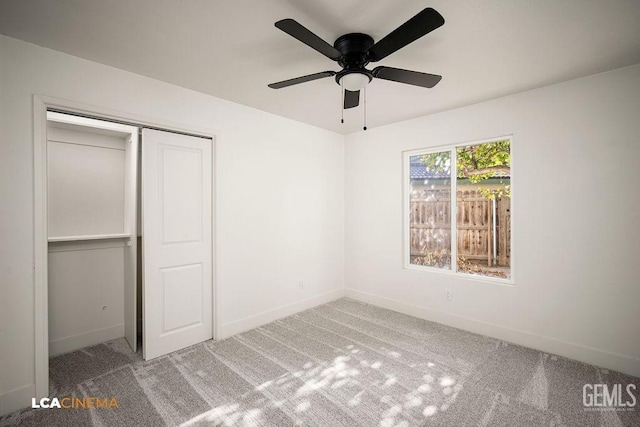 unfurnished bedroom featuring carpet floors, a closet, and ceiling fan