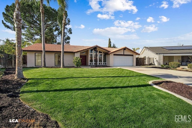 single story home featuring a front yard and a garage