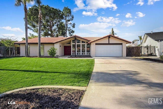 ranch-style home featuring a garage and a front lawn