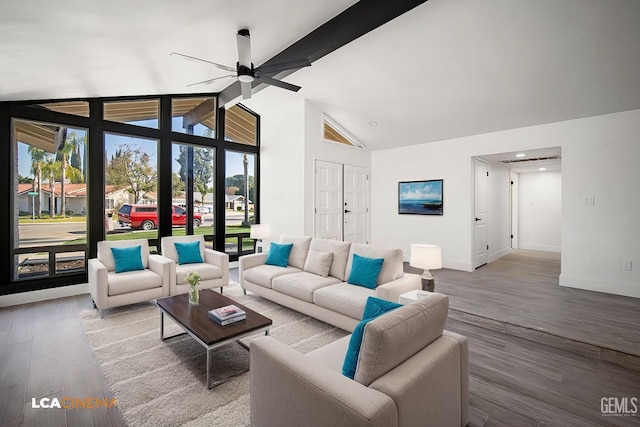 living room with vaulted ceiling with beams, hardwood / wood-style flooring, and ceiling fan