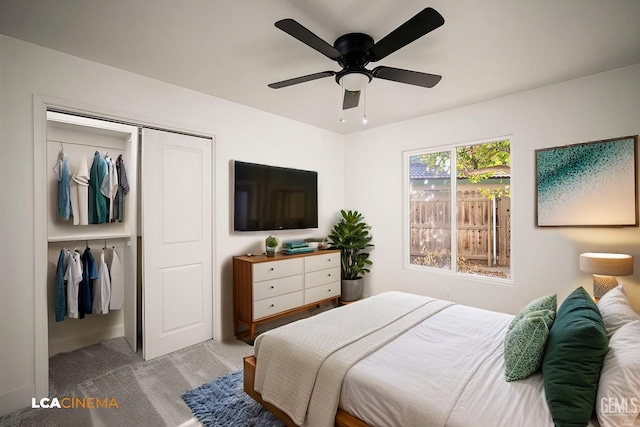 carpeted bedroom featuring ceiling fan and a closet