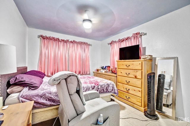 tiled bedroom featuring ceiling fan