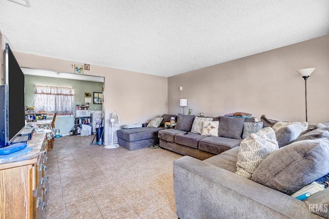 living room featuring light tile patterned floors and a textured ceiling