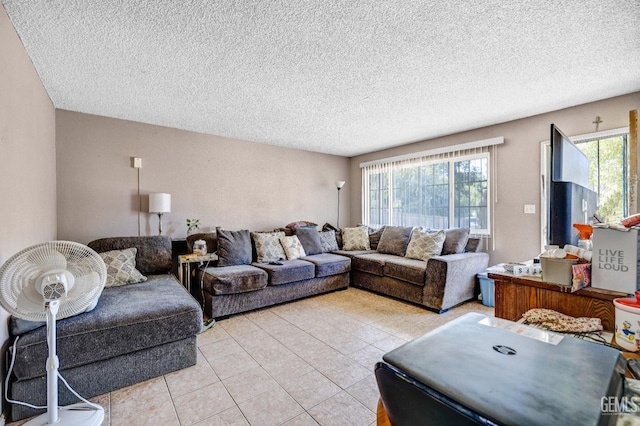 tiled living room featuring a textured ceiling