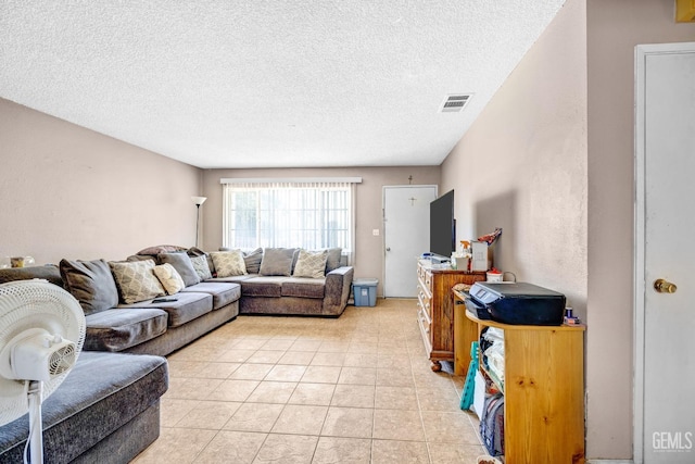 living room featuring light tile patterned floors and a textured ceiling