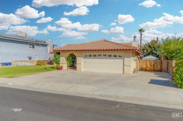 view of front of property featuring a garage and a front lawn