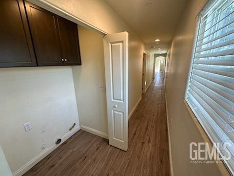 laundry room with dark wood-type flooring