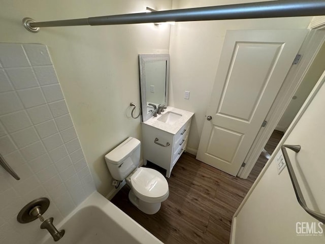 full bathroom featuring hardwood / wood-style floors, vanity, toilet, and  shower combination