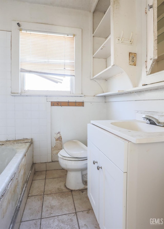 bathroom with a bathing tub, vanity, and toilet