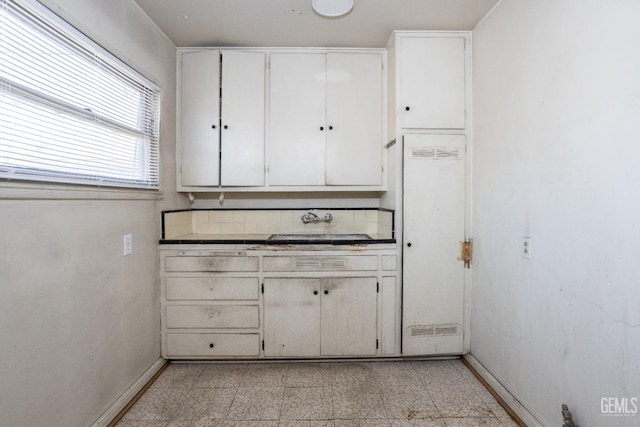 kitchen featuring white cabinets