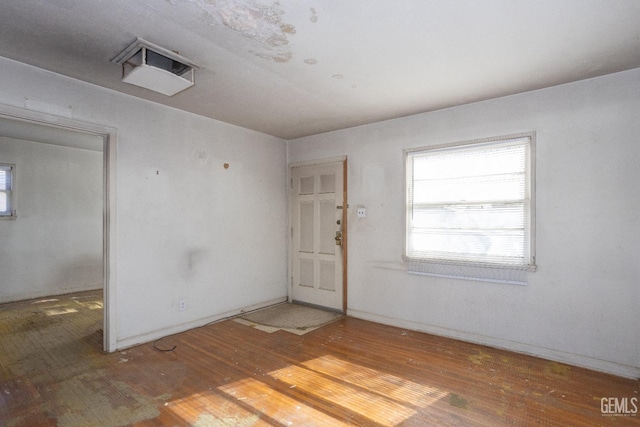 spare room featuring wood-type flooring