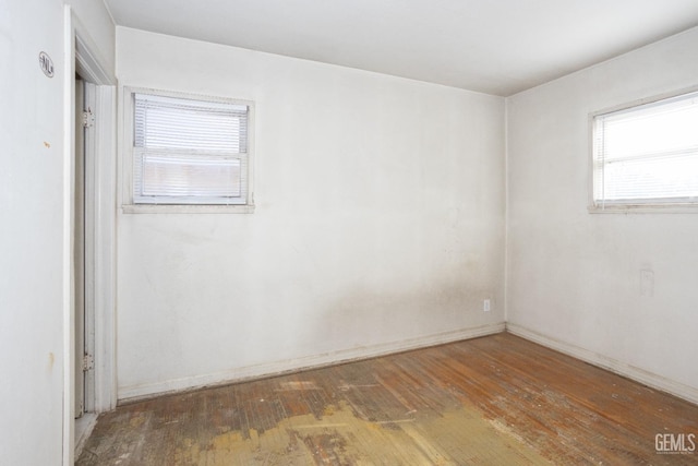 spare room with dark hardwood / wood-style floors