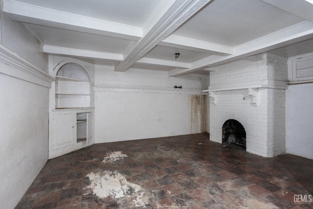 unfurnished living room featuring beamed ceiling and a brick fireplace