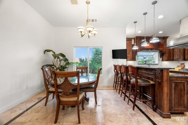 9446 E Kern River Ave, Bakersfield, CA 93308 - dining room featuring a chandelier, healthy amount of natural light, recessed lighting, and light marble finish flooring