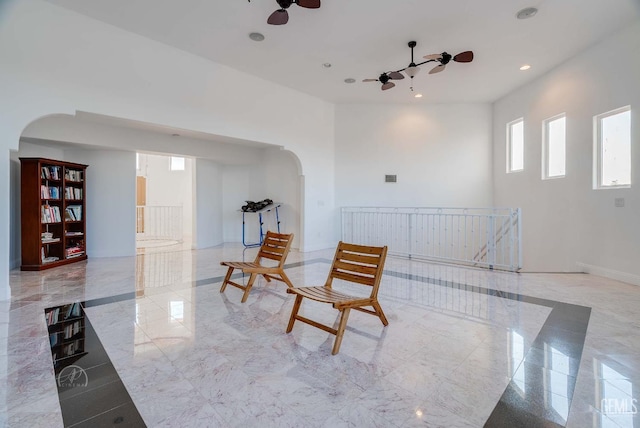 9446 E Kern River Ave, Bakersfield, CA 93308 - living area with arched walkways, a ceiling fan, and recessed lighting