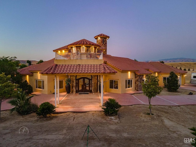9446 E Kern River Ave, Bakersfield, CA 93308 - back of property with a tiled roof, stucco siding, and a balcony