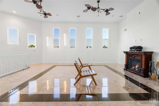 9446 E Kern River Ave, Bakersfield, CA 93308 - unfurnished living room featuring recessed lighting, a glass covered fireplace, ceiling fan, and inlaid floor details