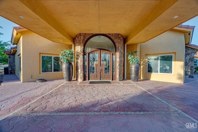 9446 E Kern River Ave, Bakersfield, CA 93308 - property entrance with french doors, stucco siding, and stone siding