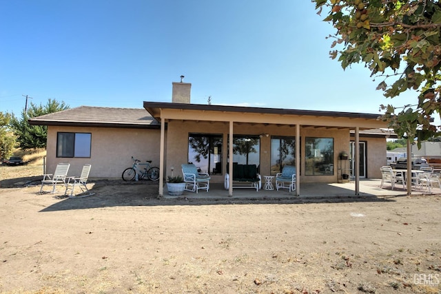 rear view of house with a patio