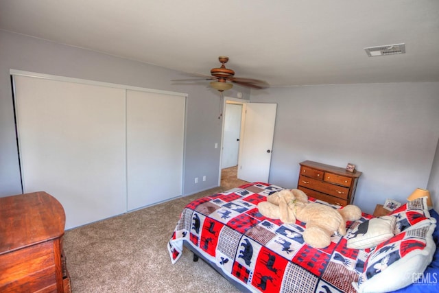 bedroom with ceiling fan, a closet, and carpet