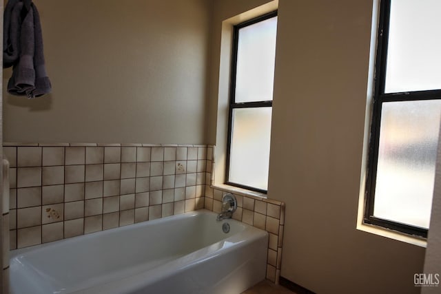 bathroom featuring a bathtub and a healthy amount of sunlight