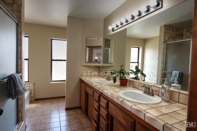 bathroom with tile patterned flooring, vanity, and plus walk in shower