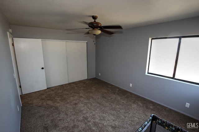 unfurnished bedroom with carpet floors, a closet, and ceiling fan