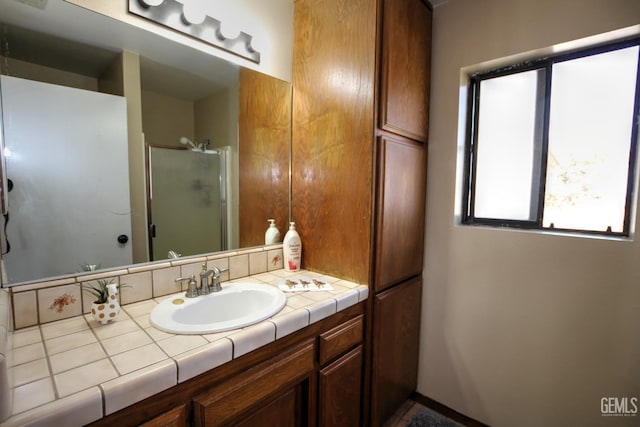 bathroom with vanity and a shower with shower door