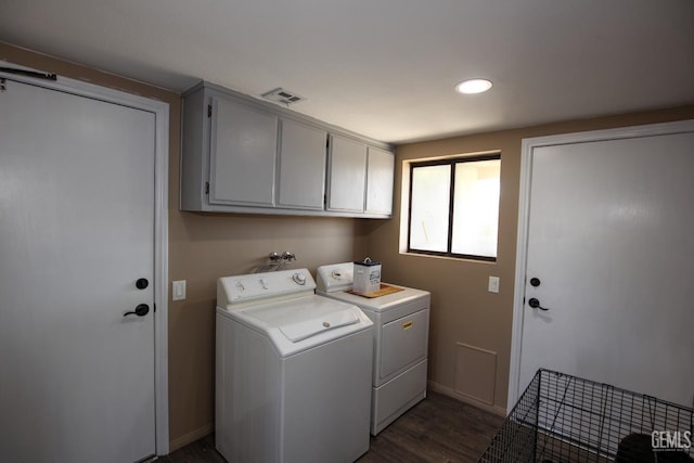 laundry room with dark hardwood / wood-style floors, cabinets, and independent washer and dryer