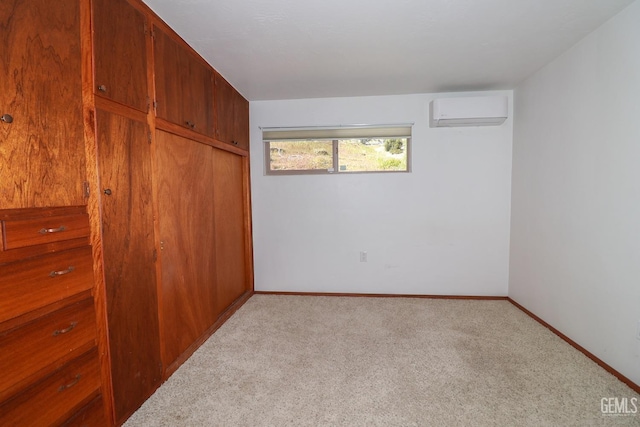 unfurnished bedroom featuring light colored carpet, an AC wall unit, and a closet