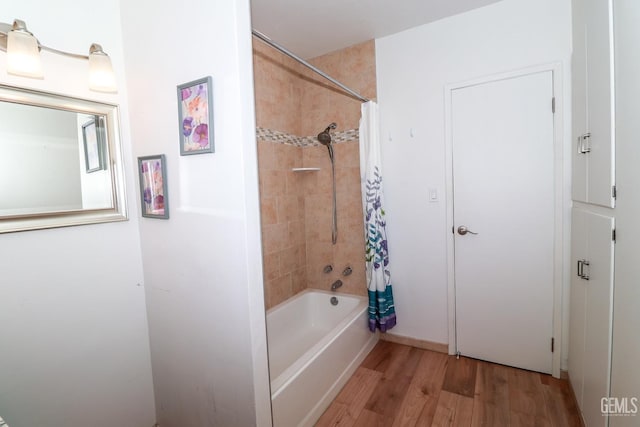 bathroom with shower / bath combo and hardwood / wood-style flooring