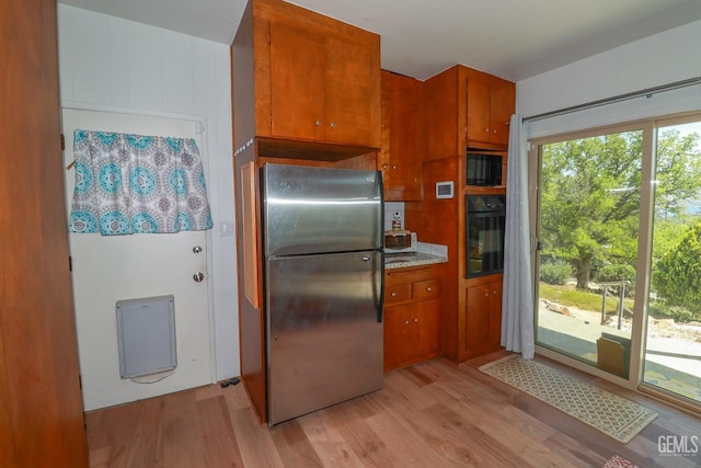 kitchen featuring black appliances and light wood-type flooring