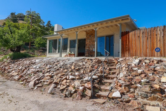 rear view of house featuring a sunroom