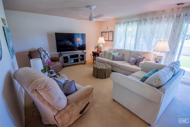 carpeted living area featuring a textured ceiling and a ceiling fan