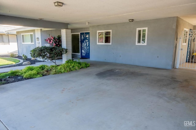 entrance to property with stucco siding