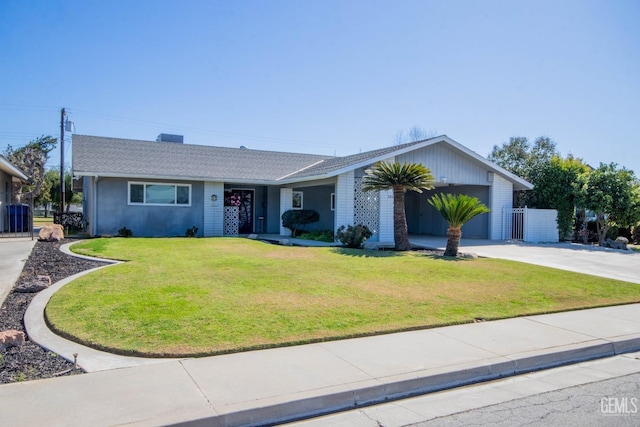 ranch-style house featuring driveway, a front yard, and a garage