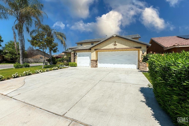 view of front of property with an attached garage, stone siding, driveway, and stucco siding