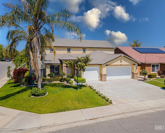 traditional home featuring an attached garage, driveway, a tiled roof, stucco siding, and a front yard