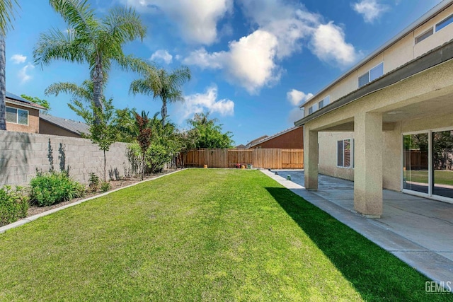 view of yard with a fenced backyard and a patio