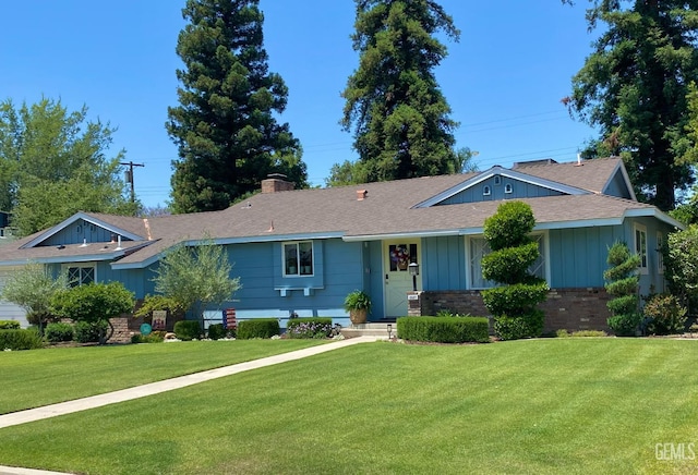 2527 Pine St, Bakersfield, CA 93301 - ranch-style house featuring a front lawn, board and batten siding, a chimney, a shingled roof, and brick siding