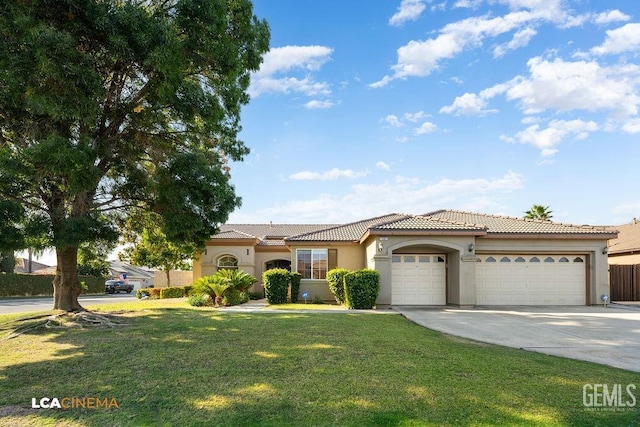 mediterranean / spanish house featuring a front yard, driveway, stucco siding, a garage, and a tiled roof