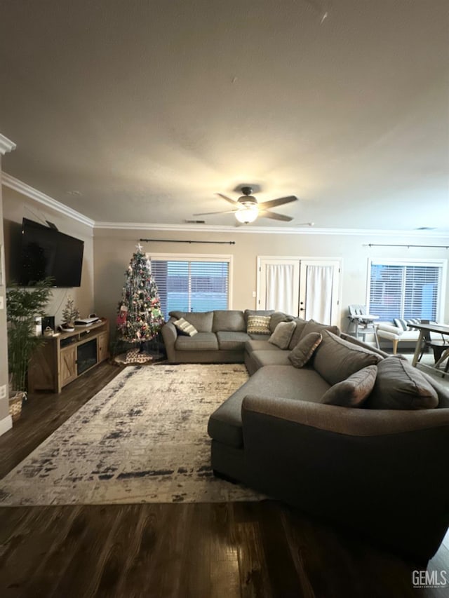 living room with crown molding, dark hardwood / wood-style flooring, and ceiling fan